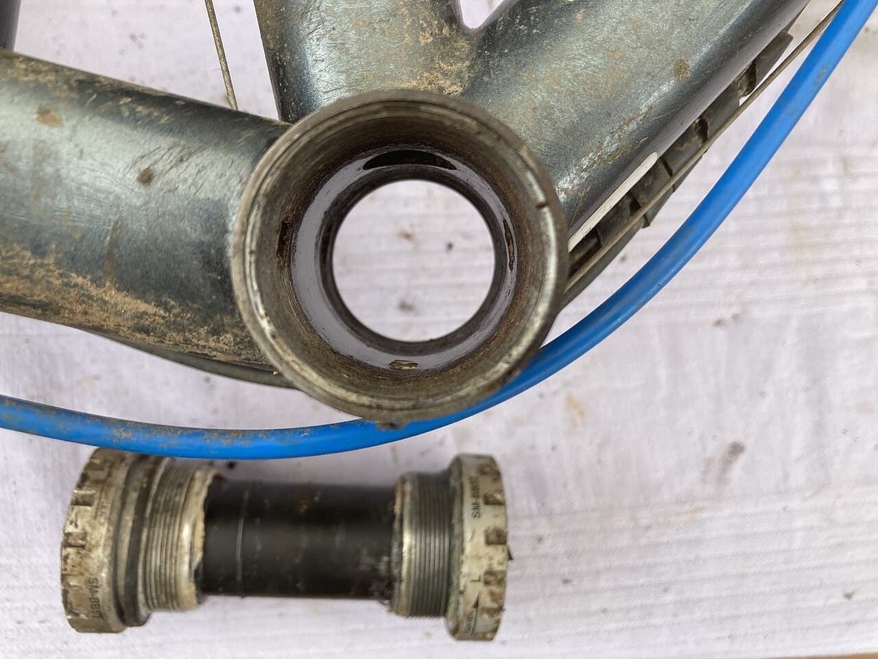 A bicycle bottom bracket shell with the crank and bottom bracket components removed