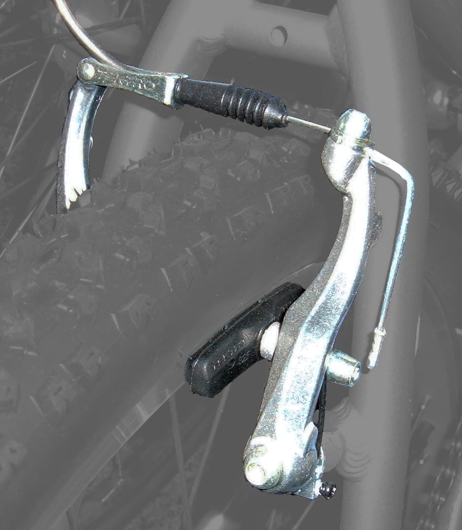Highlighted V-brake with two long arms mounted beside the wheel rim