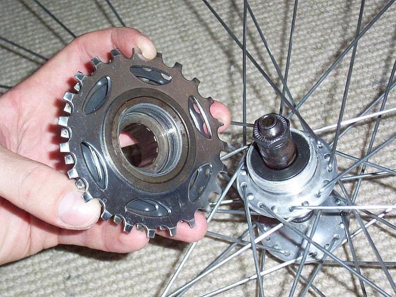 Threaded freewheel separated from a bicycle hub with visible external mounting threads