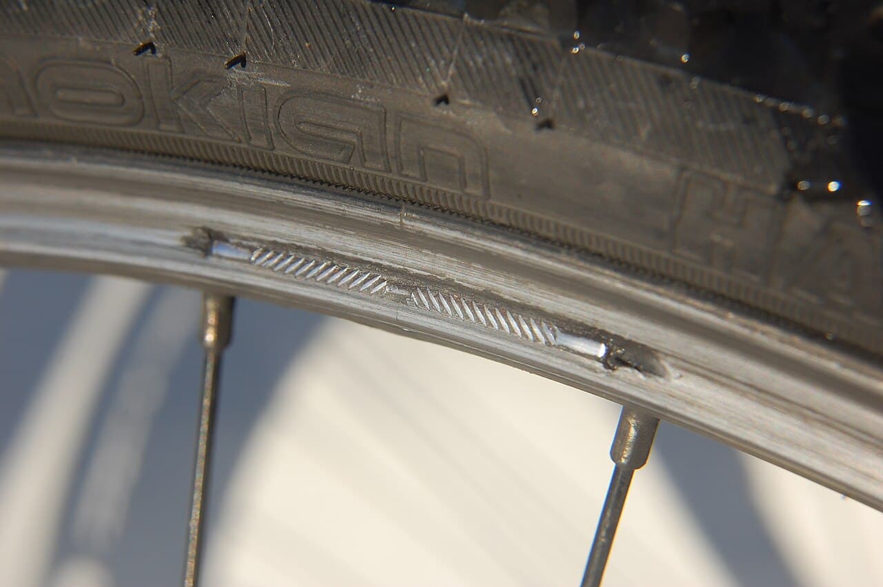 A real bicycle rim with a dangerously worn V-brake track