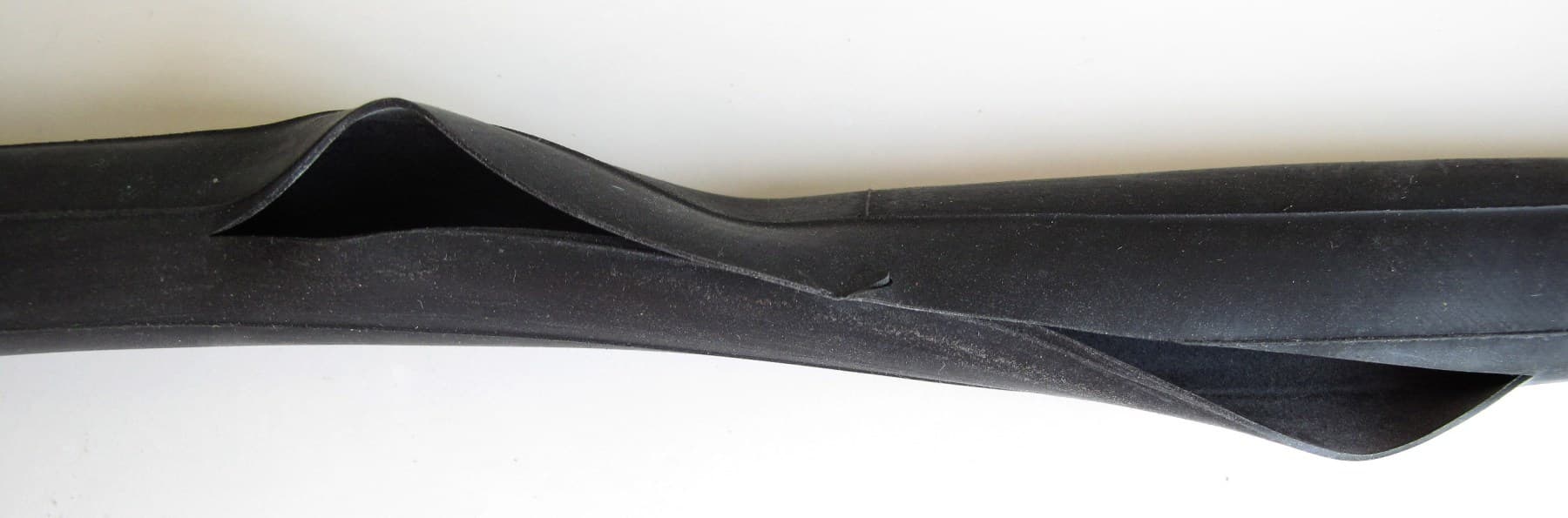 A bicycle inner tube with a long split after a containment or inflation failure