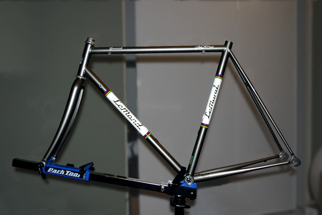 A bicycle frame supported by an axle and bottom-bracket style repair stand